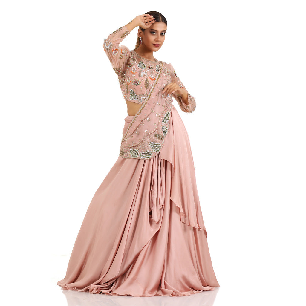 A woman standing and wearing Blush Pink Pearl Drape Lehenga.