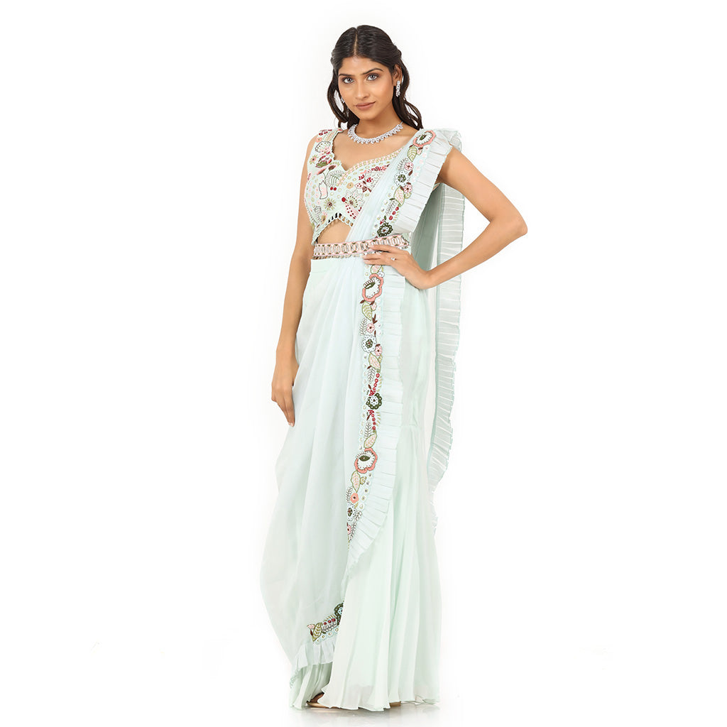 A woman standing and wearing Sea Green Colored Palazzo Saree.