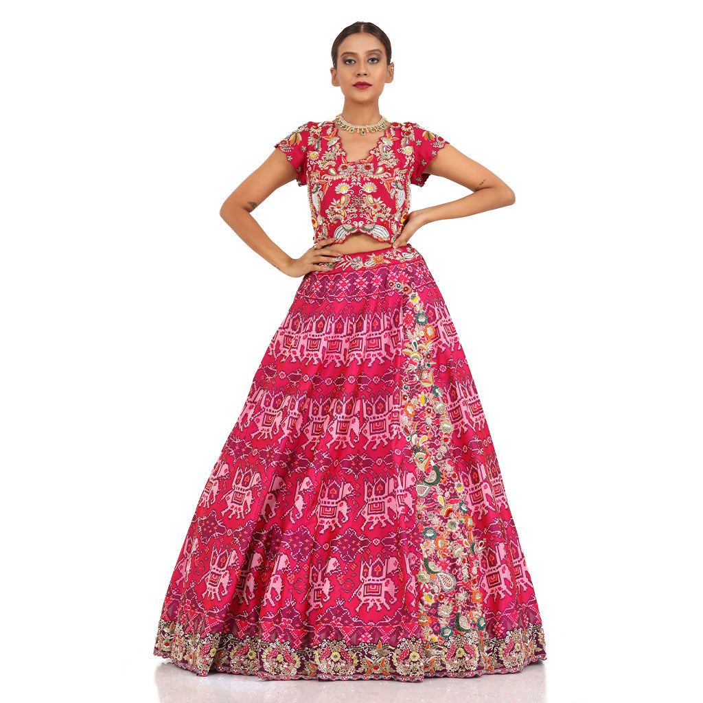 A woman wearing Elephant Motif Patola Lehenga.