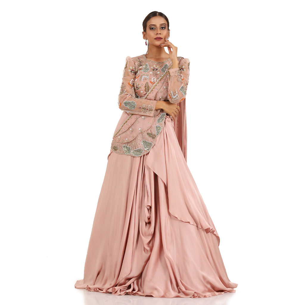 A woman standing and wearing Blush Pink Pearl Drape Lehenga.