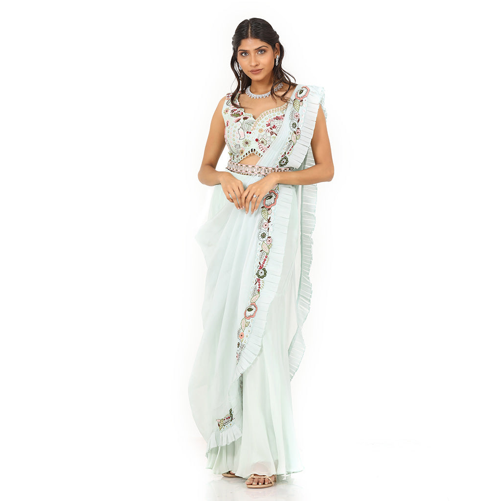 A woman standing and wearing Sea Green Colored Palazzo Saree.