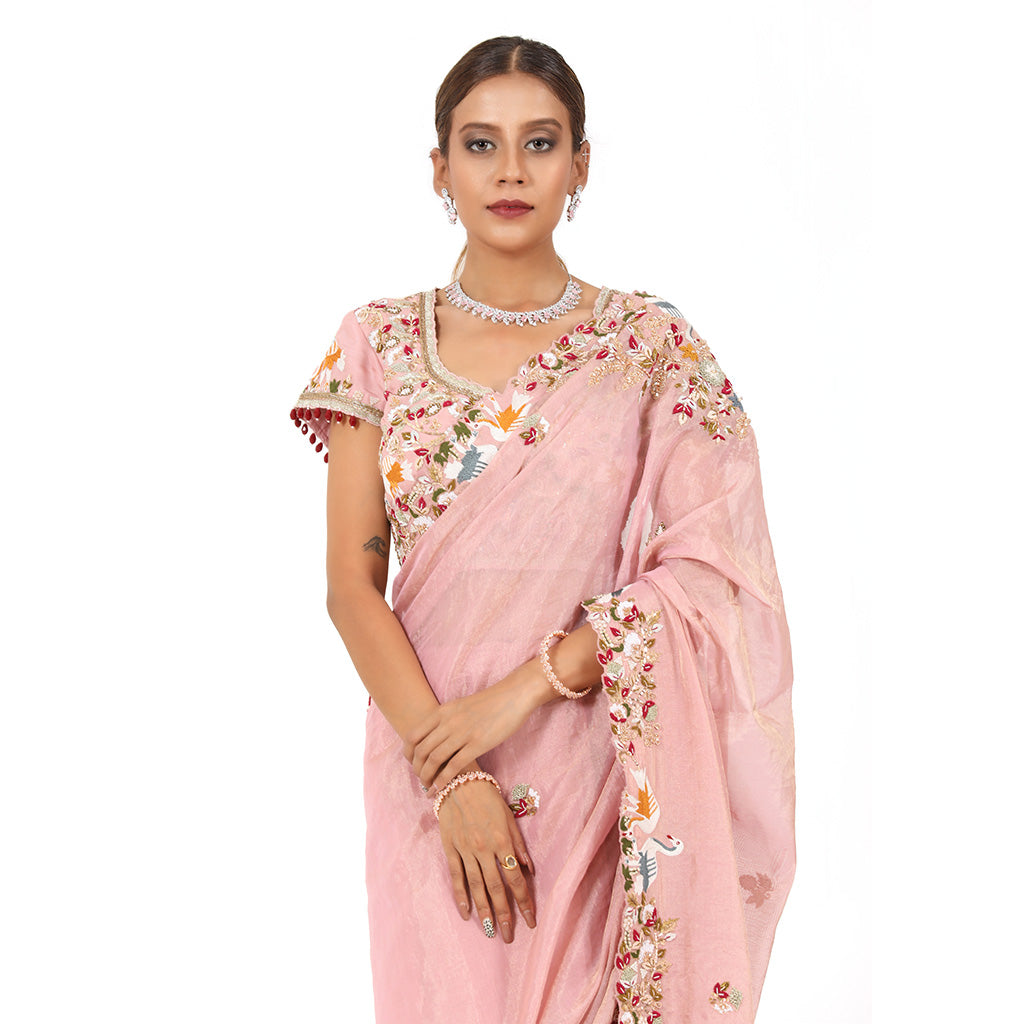 A woman wearing Pink Swan Saree.