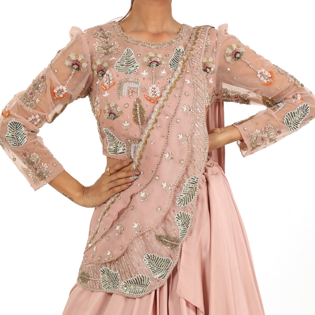A woman standing and wearing Blush Pink Pearl Drape Lehenga.