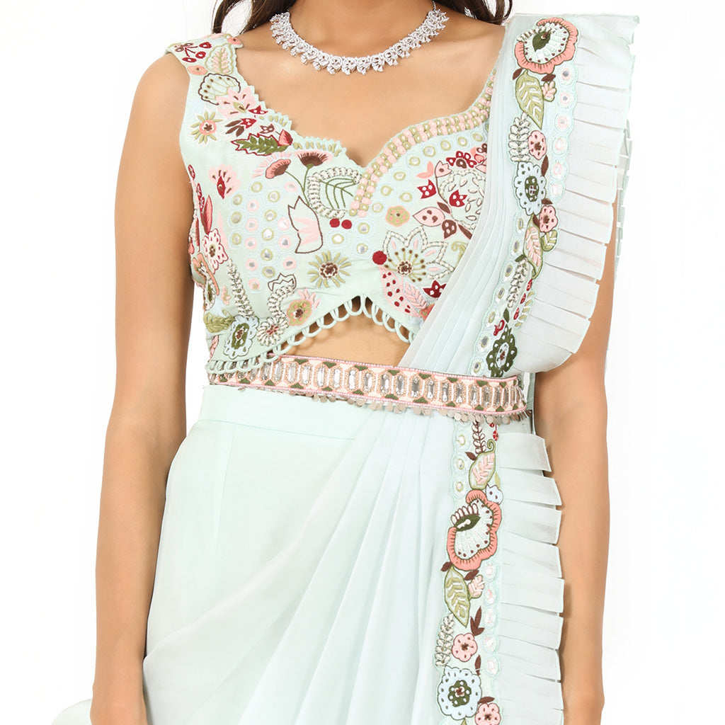 A woman standing and wearing Sea Green Colored Palazzo Saree.
