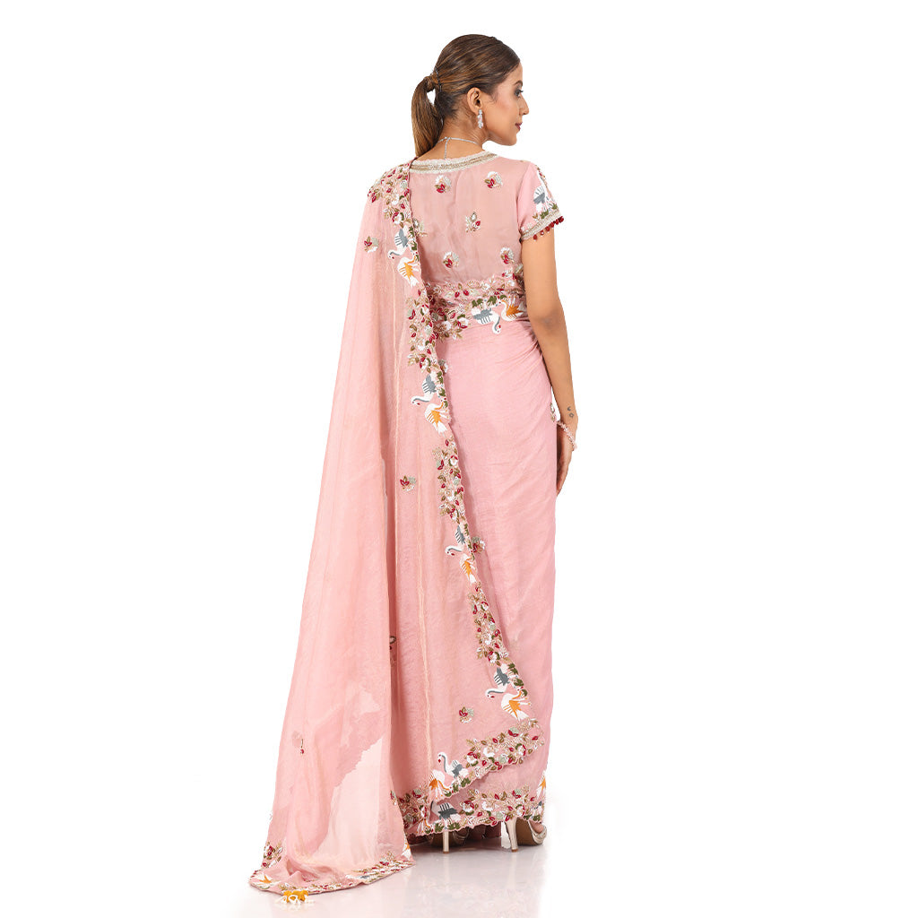 A woman wearing Pink Swan Saree.