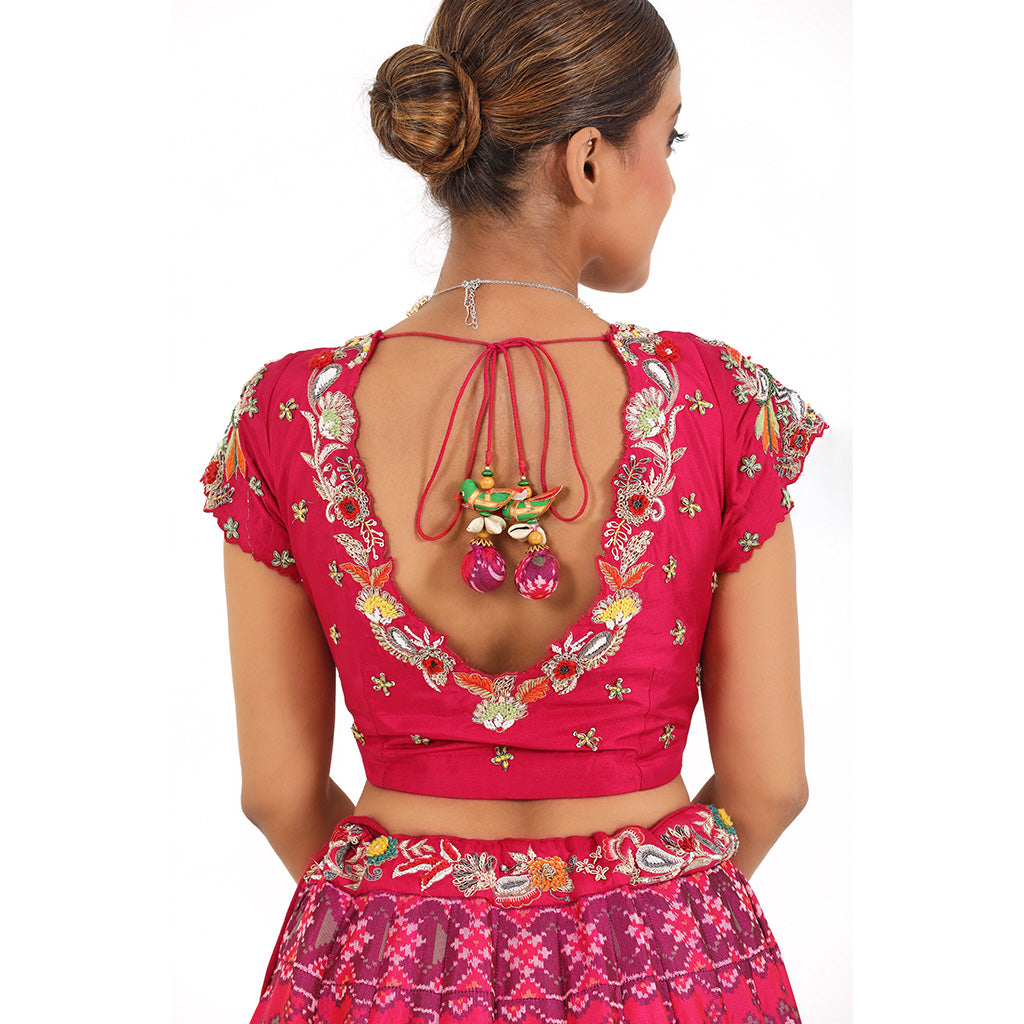 A woman wearing Elephant Motif Patola Lehenga.