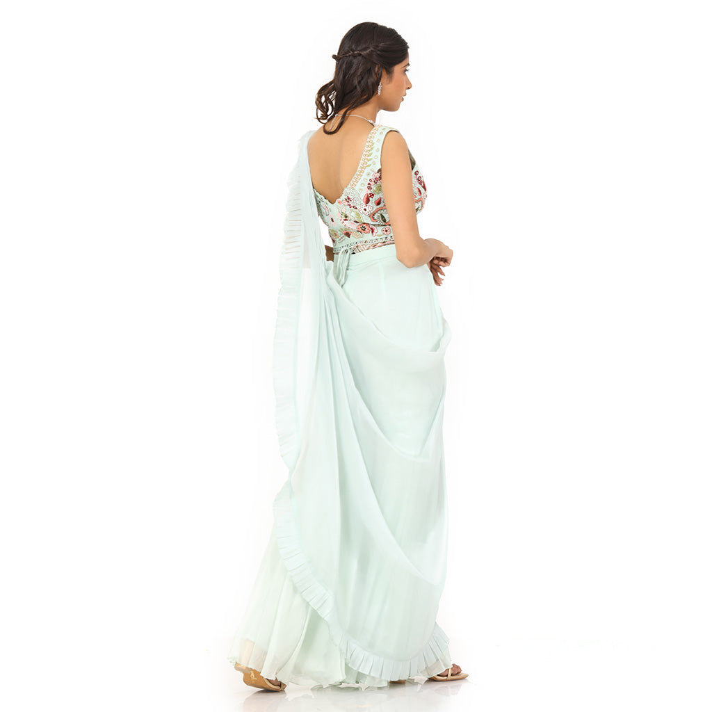 A woman standing and wearing Sea Green Colored Palazzo Saree.