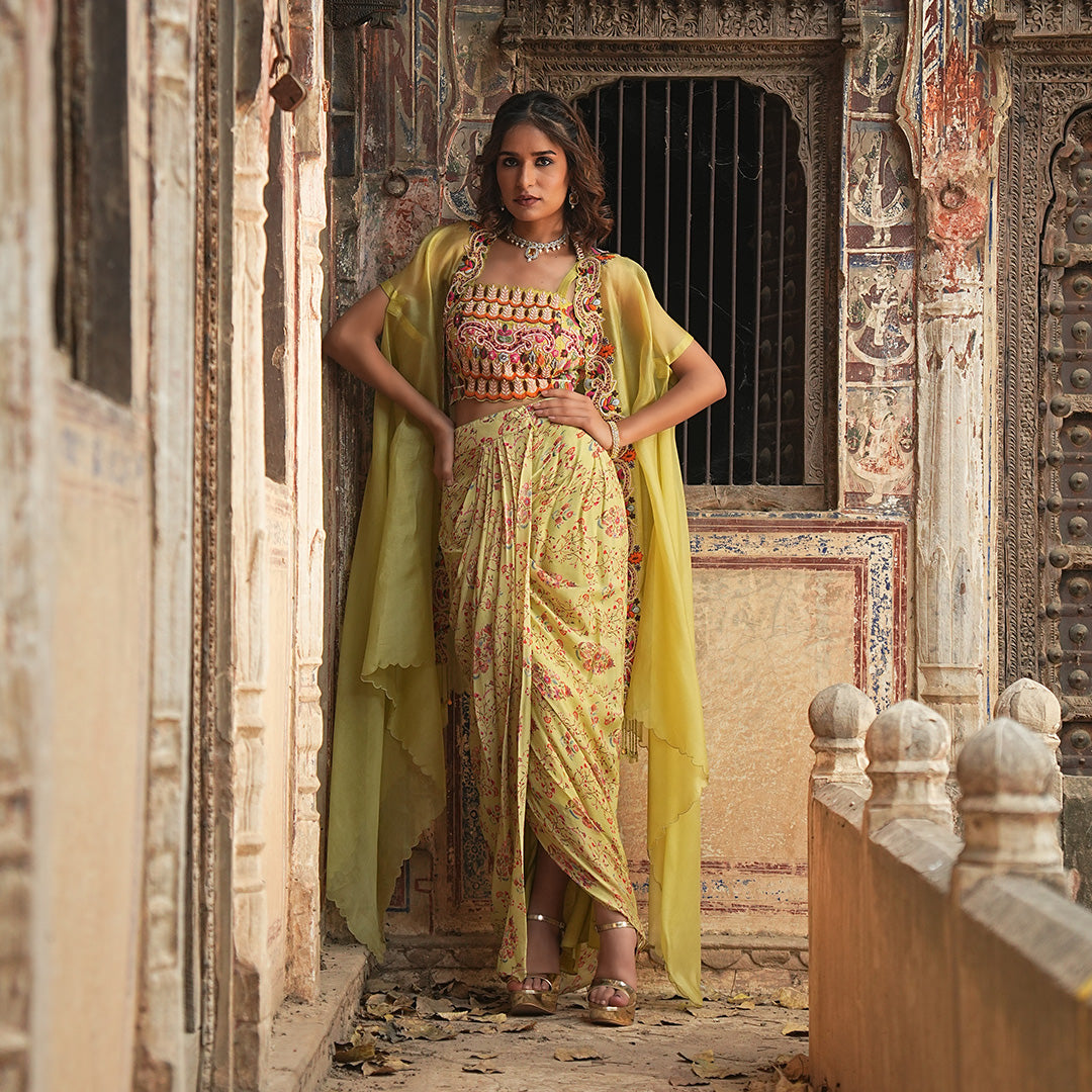 A woman standing and wearing Printed Drape Skirt with Cape.