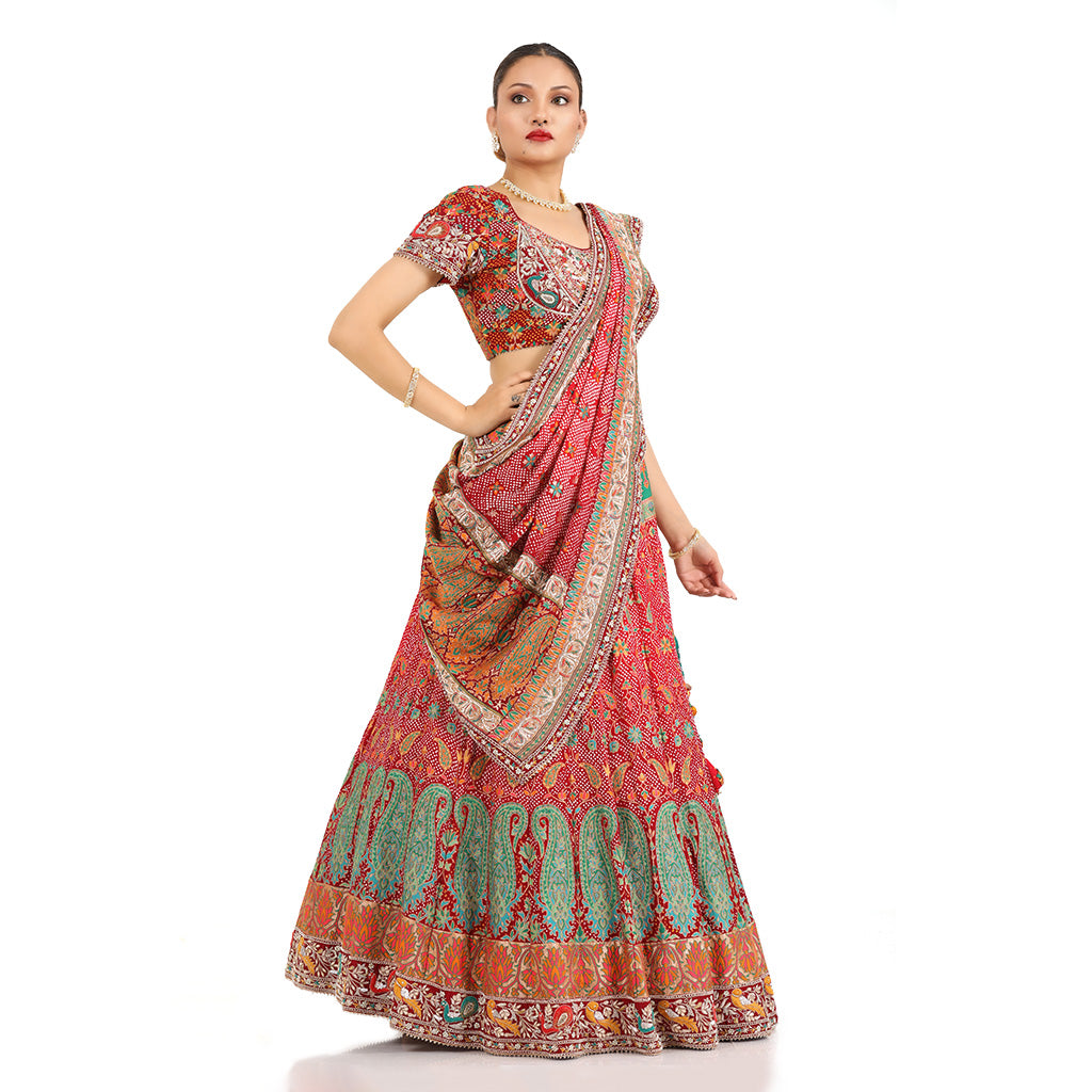 A woman standing and wearing Banarsi Georgette Bandhani Lehenga Set.