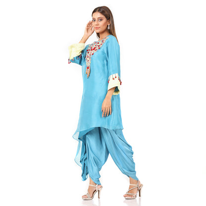 A woman standing and wearing sky blue colored Side Tail Dhoti Set.