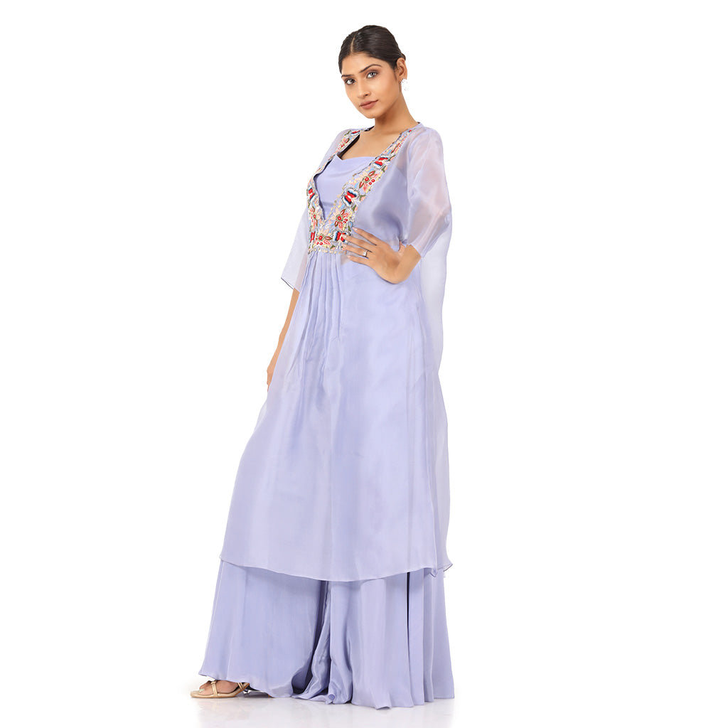 A woman standing and wearing Lavender Sheer Kurta Set.