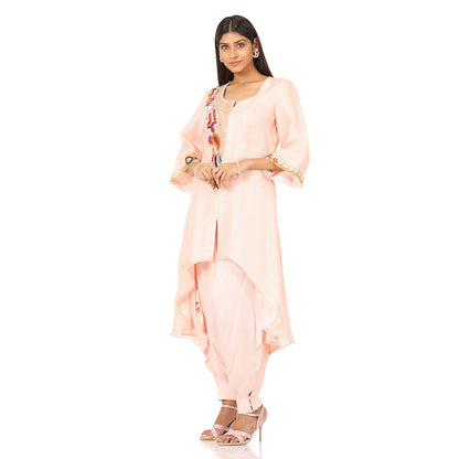 A woman standing and wearing Pink colored Asymmetrical Placement Harem Set.