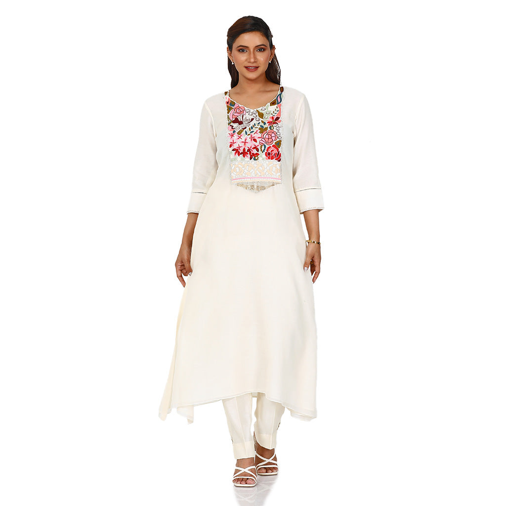 A woman standing and wearing A-Line Multifloral Kurta with Pants.