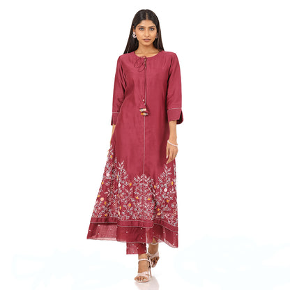 A woman standing and wearing pink colored Floral French Knot Kurta Set.