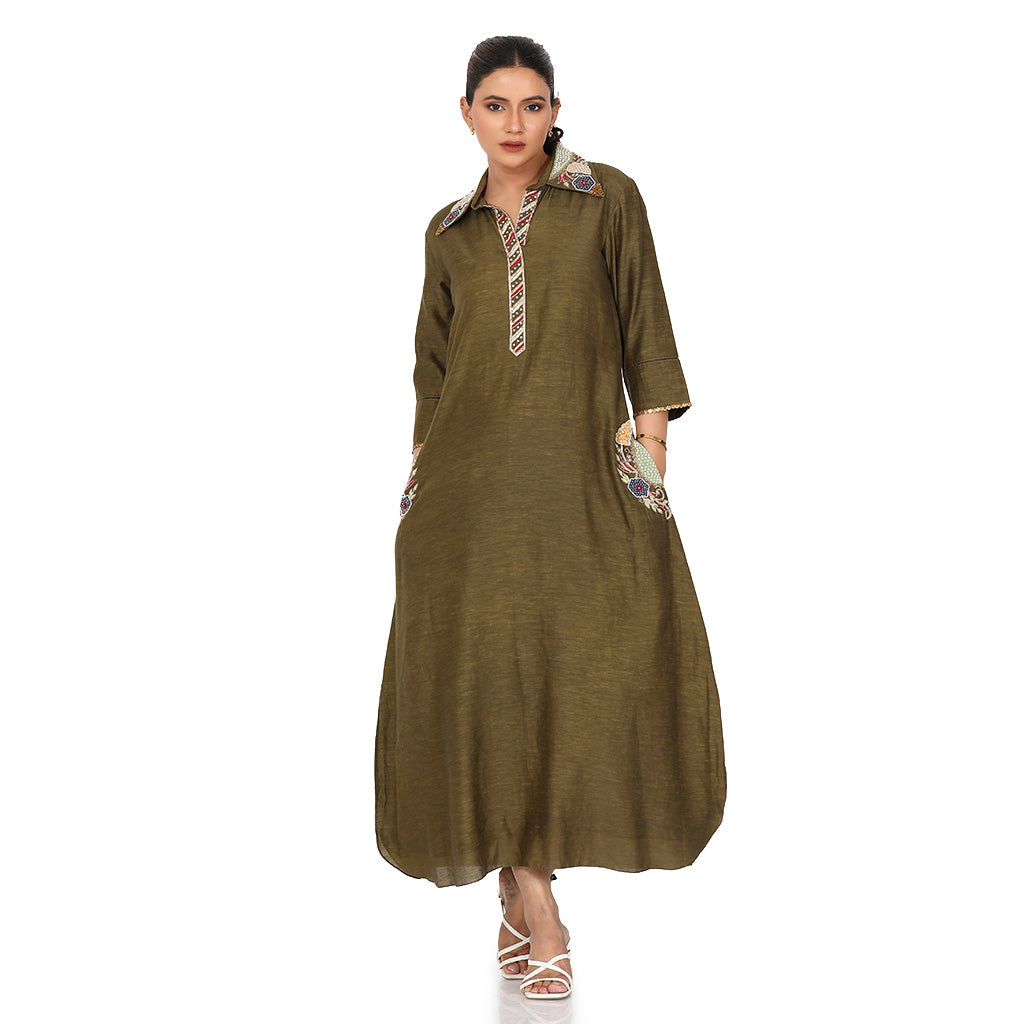 A woman wearing olive green colored pocket embroidery tunic.