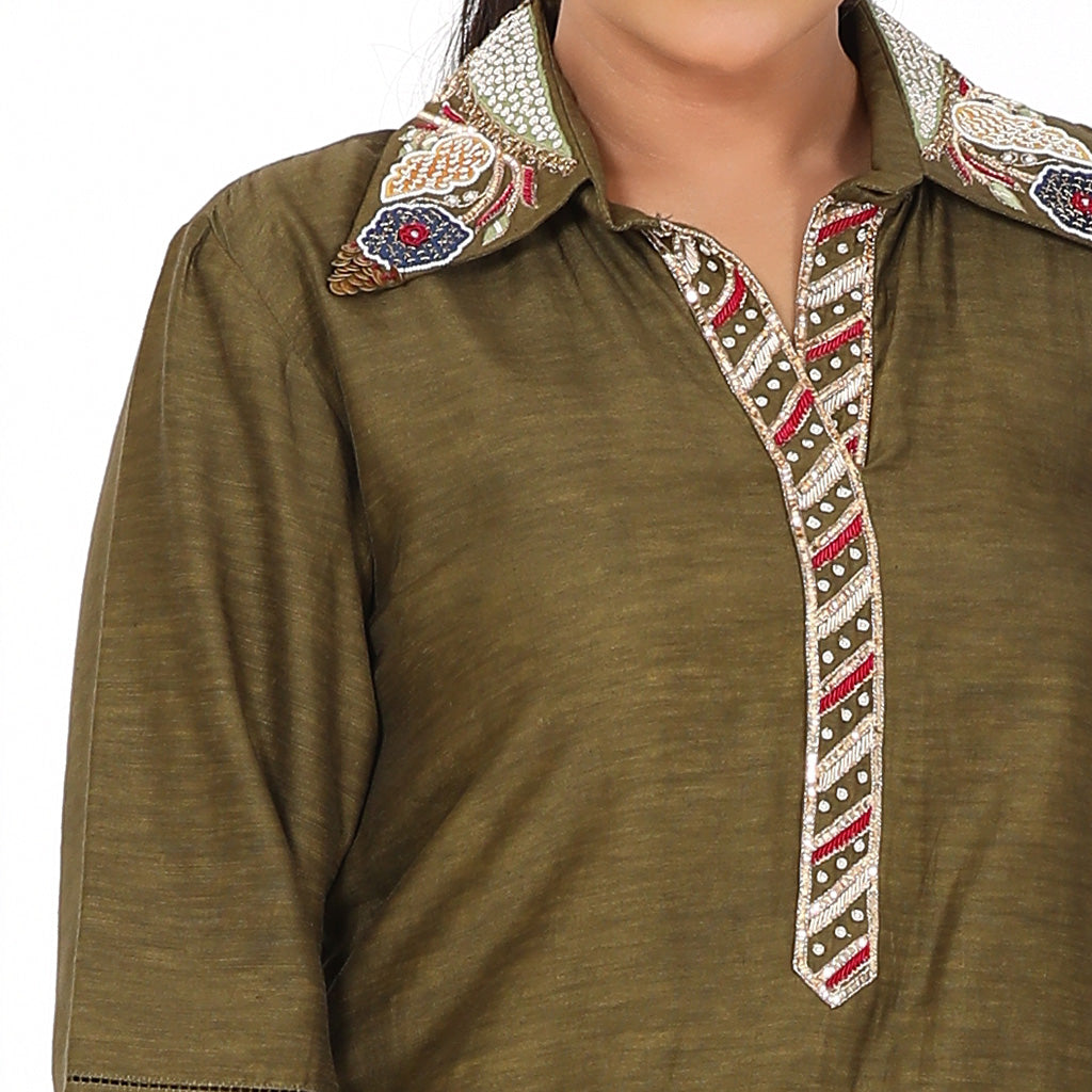 A woman wearing olive green colored pocket embroidery tunic.