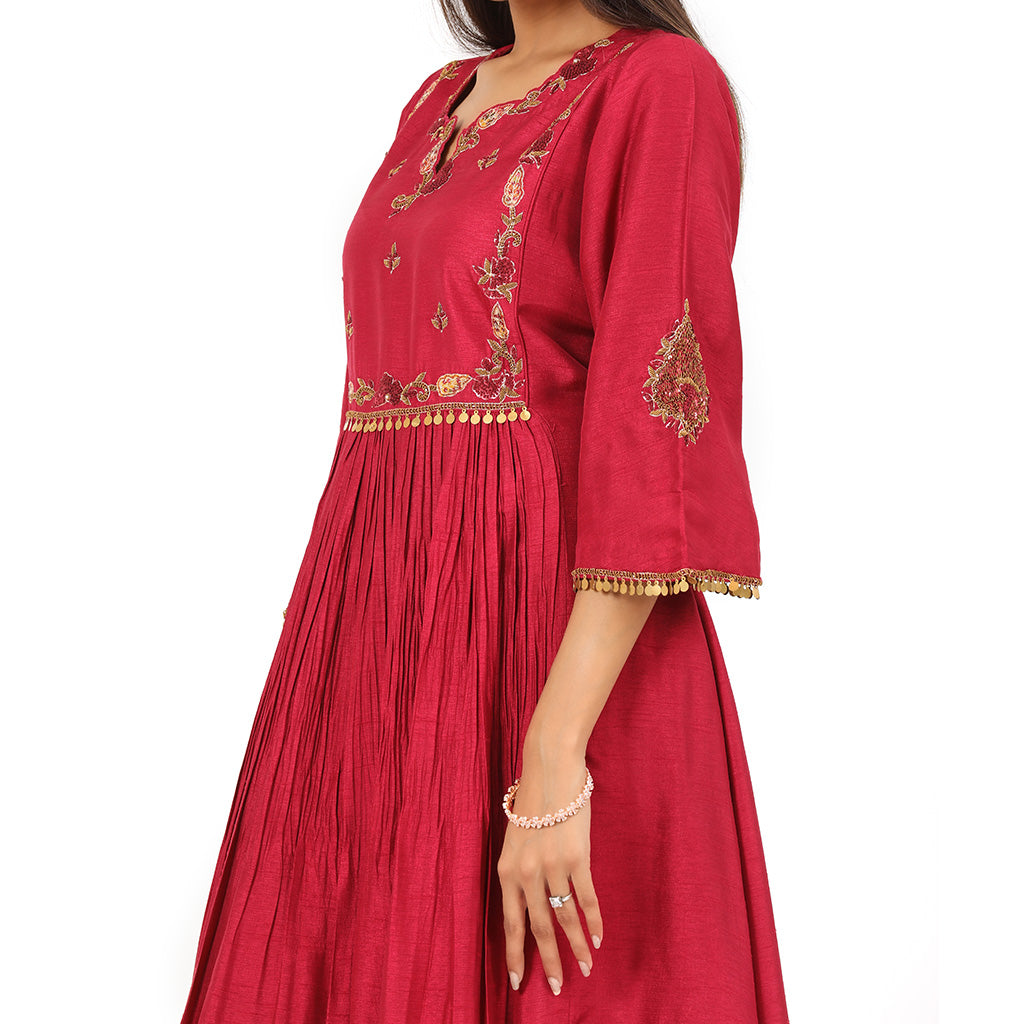 A woman standing and wearing red colored Gathered Yoke Style Tunic.