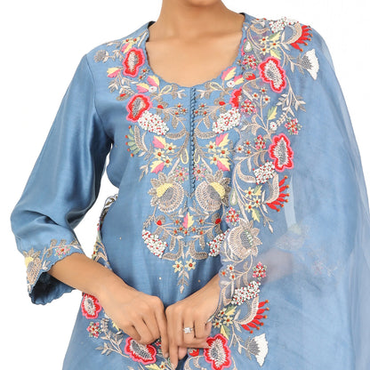 A woman standing and wearing Indigo Blue Pearl Work Kurta Sharara Set.