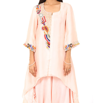 A woman standing and wearing Pink colored Asymmetrical Placement Harem Set.