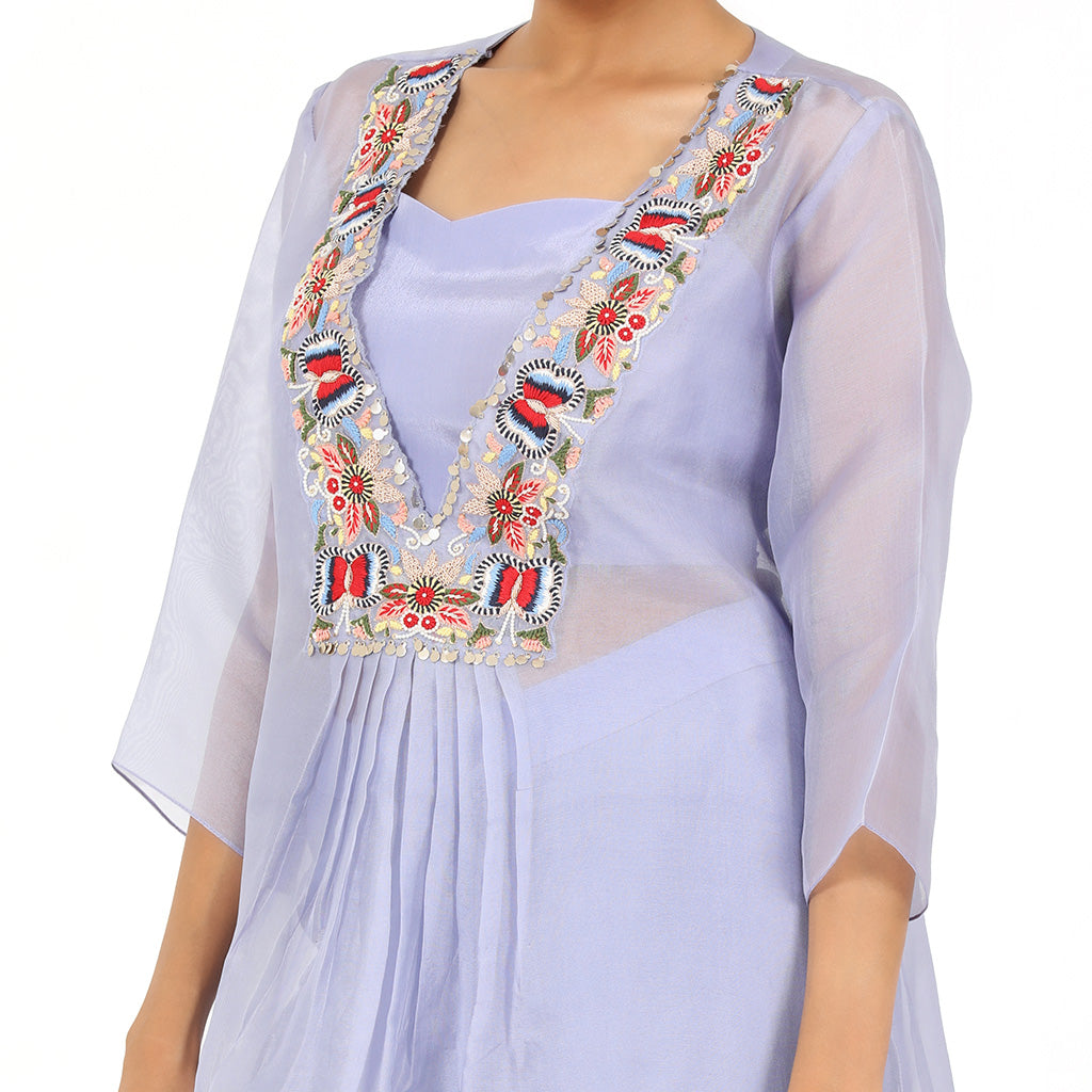 A woman standing and wearing Lavender Sheer Kurta Set.