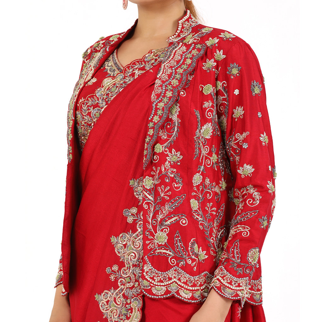 A woman standing and wearing Red Colored Jacket Saree.