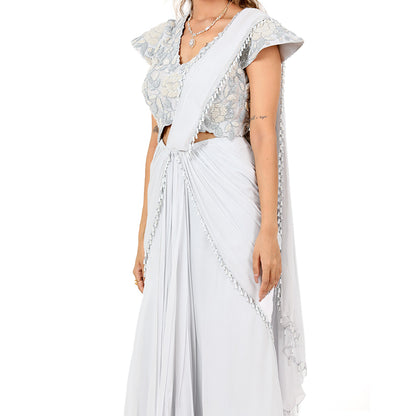 A woman standing and wearing Georgette Tassel Saree.