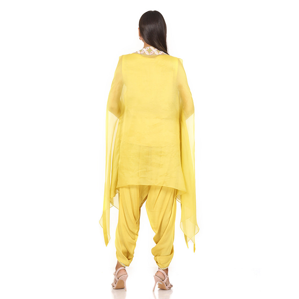 A woman standing and wearing Lemon Colored Cape Kaftan Dress.