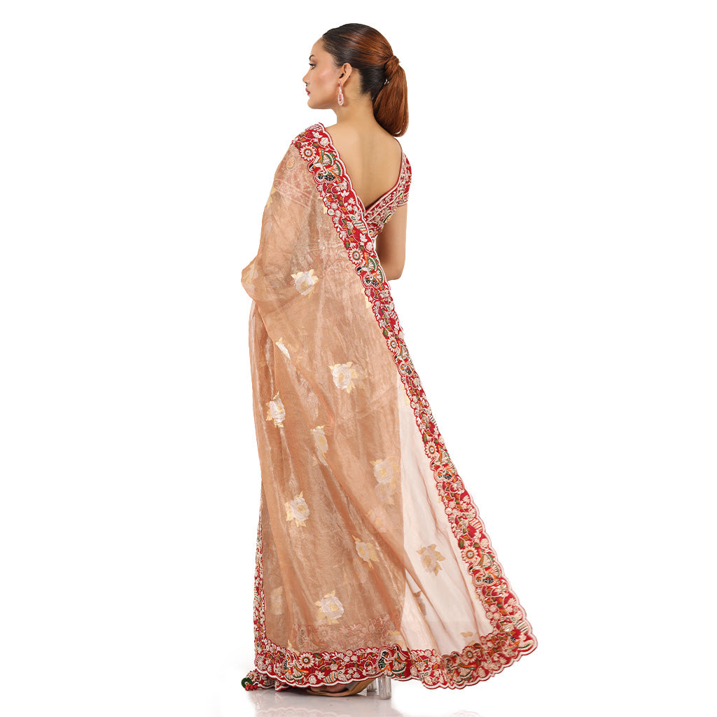 A woman wearing Pink Colored Self Gold Tissue Saree.