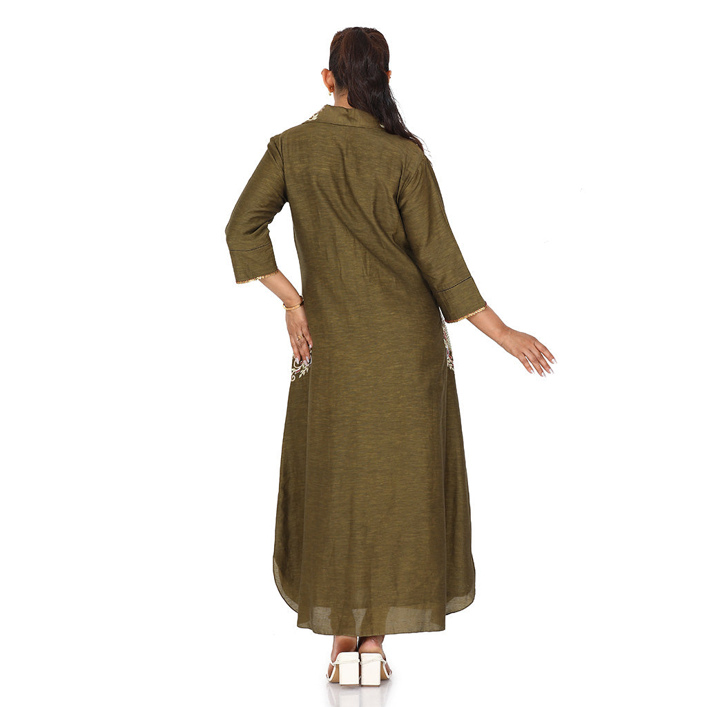 A woman wearing olive green colored pocket embroidery tunic.