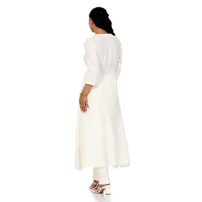 A woman standing and wearing white colored Ivory Floral Placement Kurta Set.