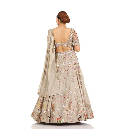 A woman standing and wearing Panda Lehenga Set.