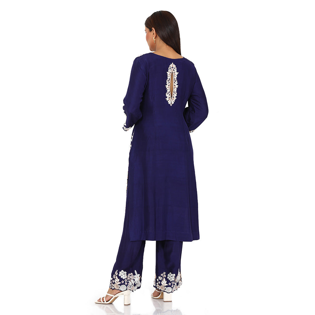 A woman standing and wearing Purple Dupion Silk Kurta Set.