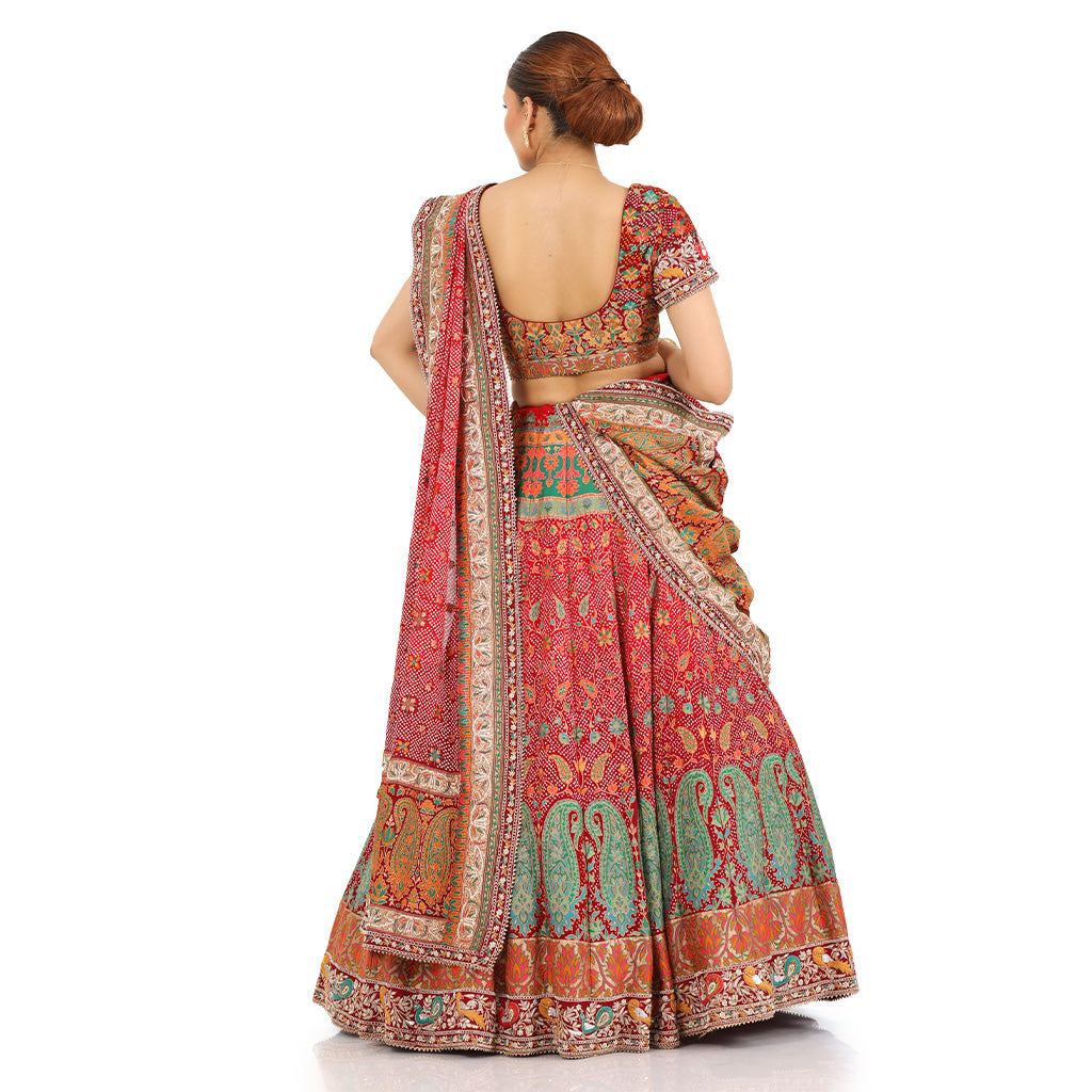 A woman standing and wearing Banarsi Georgette Bandhani Lehenga Set.