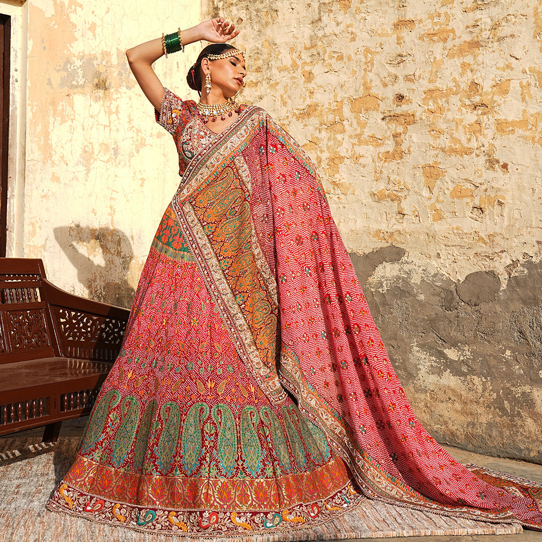 A woman standing and wearing Banarsi Georgette Bandhani Lehenga Set.