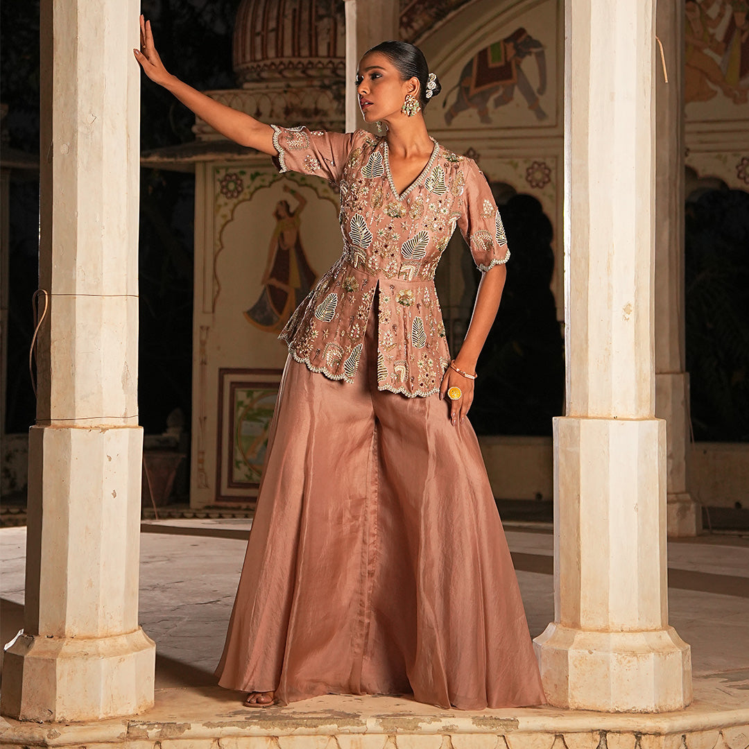 A woman standing and wearing Mocha Leaf Peplum.