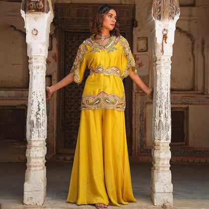 A woman standing and wearing Yellow Mirror Jacket with Palazzo.