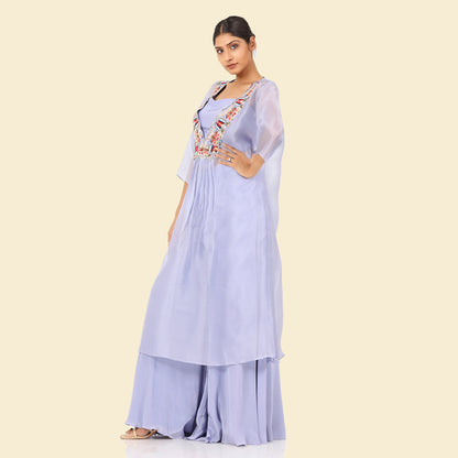 A woman standing and wearing Lavender Sheer Kurta Set.