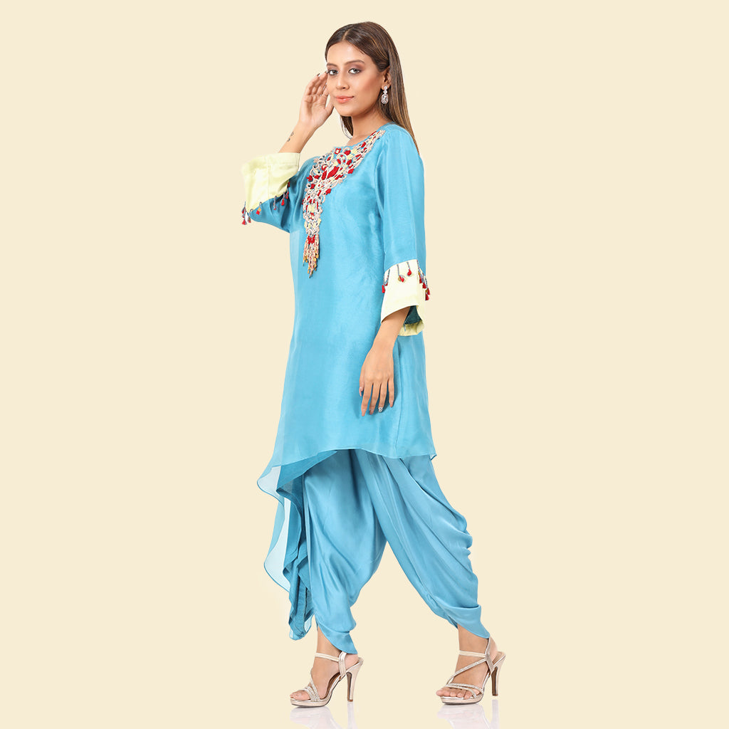 A woman standing and wearing sky blue colored Side Tail Dhoti Set.